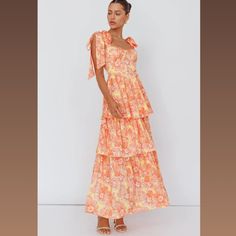 This Is A Beautiful Orange, Floral Summer Dress That Gives A Feminine Flare. It's A Perfect Dress For A Garden Party, A Wedding, Or Just A Summer Photoshoot. The Fabric Is Gorgeous And Light. Feminine Yellow Tiered Dress, Orange Tiered Dress For Brunch, Orange Tiered Dress For Day Out, Orange Feminine Maxi Dress For Brunch, Light Orange Bridesmaid Dresses, Pastel Orange Dress, Orange Bridesmaid Dresses, Floral Bridesmaid Dresses, Midi Party Dress