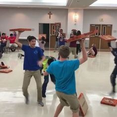 several people in a room with some carrying objects