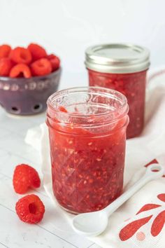 raspberry jam in a jar with fresh raspberries on the side