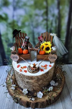 a cake decorated with two chairs and fall decorations on top of a wooden slice that has been cut into pieces