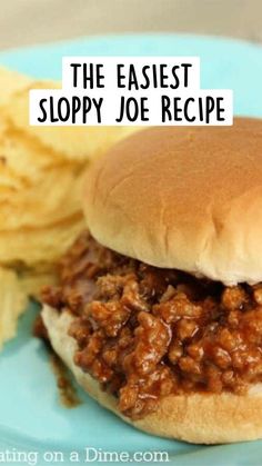 a sloppy joe sandwich and potato chips on a blue plate