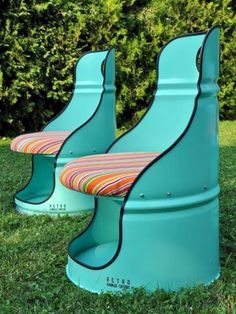 two blue plastic chairs sitting in the grass