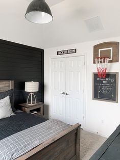 a bedroom with a bed and basketball hoop on the wall next to two door closets