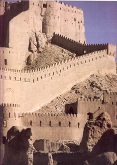 an old photo of a castle built into the side of a mountain