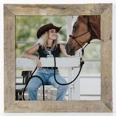 a woman sitting on a bench next to a horse and holding the bridle