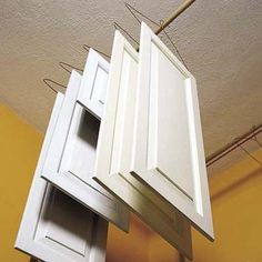 the kitchen cabinets are hanging upside down from the ceiling