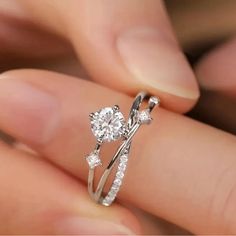 a person holding a diamond ring in their hand