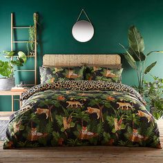 a bedroom with green walls and leopard print bedding