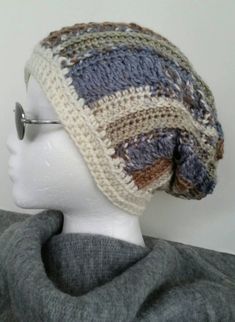 This handmade crochet slouch hat is warm, fun and very trendy. My Braided Stripe original design is one of a kind.  Soft Beach Blues with a touch of neutrals in Adult / Teen size. This hat is made using soft worsted acrylic yarn for non-itchy comfort & easy care. It can be washed in a machine and tumble dried but hand washing is recommended.  DETAILS: *  measures 22" around brim and 13" tall *  made with Deborah Norville Serenity yarn  * Other colors available on request  ** Color varies on all computer screens so please Convo me with any questions, concerns or special requests. 100% satisfaction guaranteed Bohemian Hand-knitted Crochet Hat, One Size, Warm Bohemian Beanie Hat, One Size Cotton Yarn Beanie Hat, Cotton Yarn Beanie Hat, Bohemian Brimmed Yarn Beanie, Bohemian Beanie Crochet Hat, Bohemian Slouchy Crochet Beanie, Brimmed Crochet Yarn Beanie, Handmade Bohemian Yarn Beanie