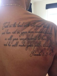 the back of a man's chest with a bible verse written on it