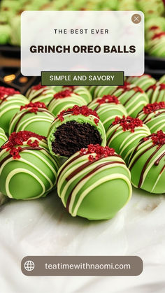 some green and white chocolates with red bows on them are sitting on a table