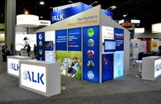 an exhibit booth with people standing around it