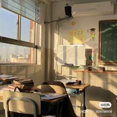 an empty classroom with desks and chairs in front of a chalkboard on the wall