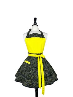 a mannequin wearing a yellow and black dress with an apron on it's waist