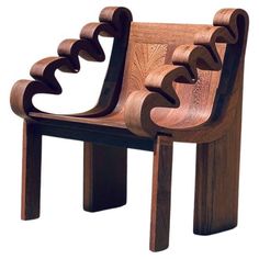 a wooden chair made out of wood with an intricate design on the back and seat