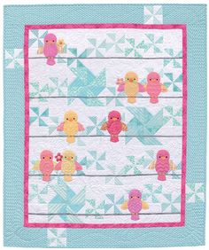 a blue and pink quilt with little birds on it