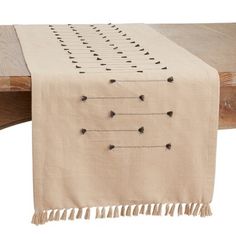 a table runner with tassels on it