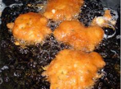 fried food being cooked in a frying pan with oil on the top and bottom