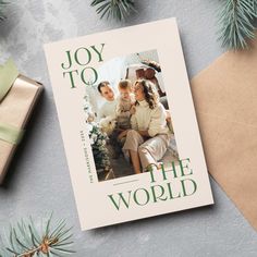 a christmas card with the words, joy to the world on it next to presents