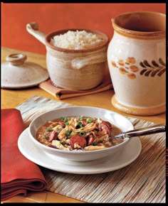 a white bowl filled with food on top of a table next to a red napkin