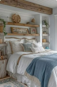 a bedroom with white bedding and wooden shelves on the wall above it, along with an area rug