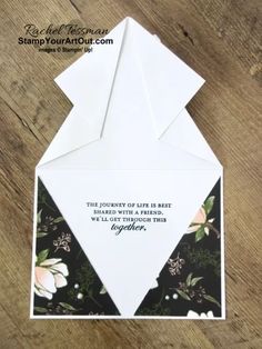 an origami card with flowers on it and a quote written in the middle