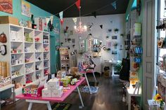 a room filled with lots of shelves and tables next to each other in front of a window