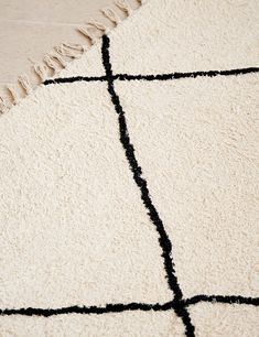 a white rug with black lines on it