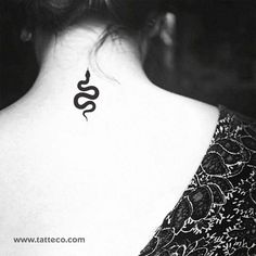 a woman with a tattoo on her back neck and the word snake written in black ink