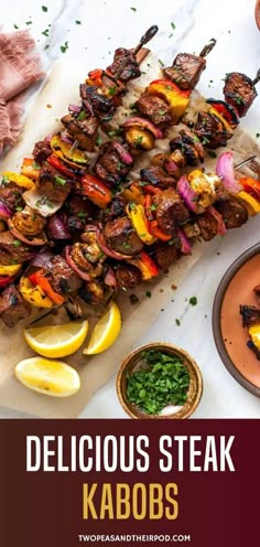 delicious steak kabobs served on skewered skewers with lemons and garnishes