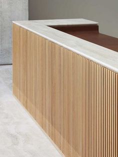 a wooden counter top sitting next to a white wall