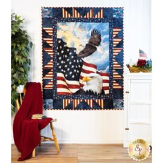 an american flag and eagle quilt hanging on a wall