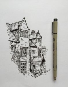 a drawing of a house with a pen in front of it and the image is drawn on paper