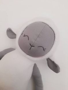 a close up of a stuffed animal on a white surface