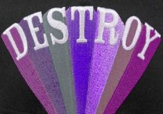 a baseball cap with the word destroy written on it in white and purple letters that spell destroy