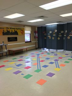 an empty room with colorful tiles on the floor and lockers in the back ground