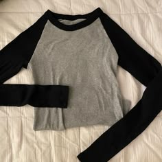 Perfect Condition Never Worn. Another Pawn In My Clothing Addiction. I Don't Even Like Long Sleeves Lmaoo I Hope Someone Wants Her. Feel Free To Bargain On All My Posts, I Offer Bundle Discounts<3 #Brandymelville #Y2k #Lace Fitted Long Sleeve Shirt Y2k, Brandy Melville Tee Shirt, Brandy Melville Must Haves, Black Long Sleeve Color Block Tops, Black Stretch Color Block Tops, Black Raglan Sleeve T-shirt For Fall, Fitted Gray Color Block Tops, Black Color Block Tops For Fall, Trendy Heather Grey Stretch Tops