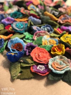 several different colored flowers are laying on the table together, and there is no image here to provide a caption for