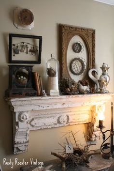 an old fireplace mantel with candles and pictures on it