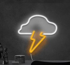 a neon sign with a lightning coming out of it's cloud on a black wall