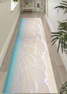 the floor is painted with blue and white water in an empty room next to a plant