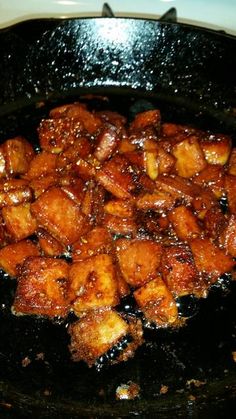 some food is cooking in a black pan on top of the stovetop and ready to be eaten