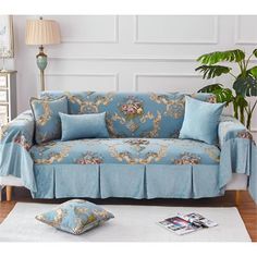 a living room with a couch covered in blue covers