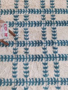 a wooden chair sitting on top of a blue and white rug