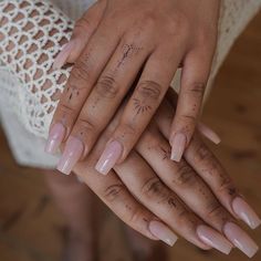 two hands holding each other with nails on them