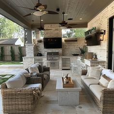 an outdoor kitchen and living area with wicker furniture