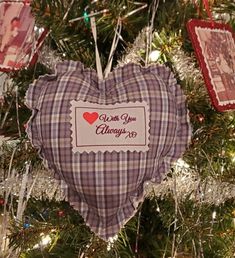 a heart shaped ornament hanging from a christmas tree