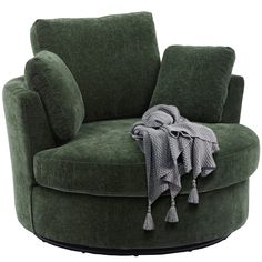 a green chair with a blanket on it