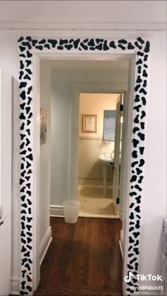 the hallway is decorated with black and white wallpaper, which has an animal print border