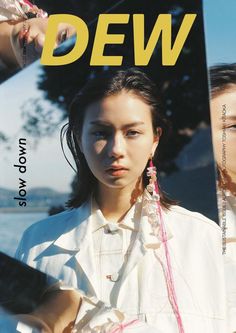 the cover of dew magazine features an image of a woman in white shirt and pink earrings